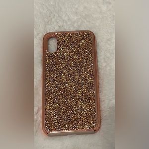 A rose gold phone case with rhinestones, hardly used, and perfect condition.